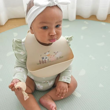 Demonstration of the waterproof and easy to clean material of Little Rawr toddler aprons