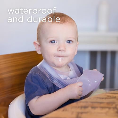 Olababy lightweight food grade silicone bib rolled up and tucked neatly inside its plastic travel container.