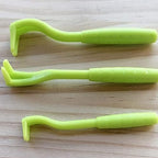 Tick removal tools held in hand for size reference