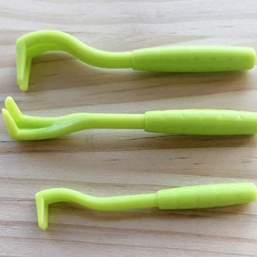 Tick removal tools held in hand for size reference