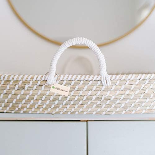 Handwoven changing basket displaying integrated handles and waterproof sheet