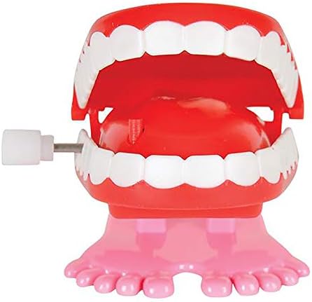 Close up view of the clockwork winding key on the side of the plastic teeth toy