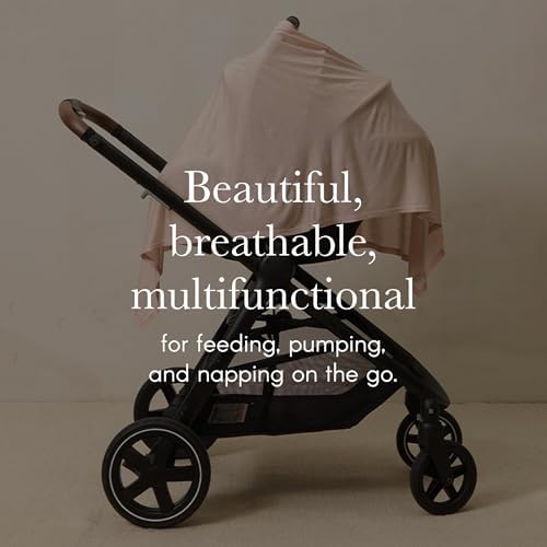 Mother using Solly Baby cover for discreet breastfeeding