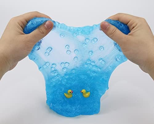 Close up view of the small plastic duck charms embedded inside the blue crunchy slime