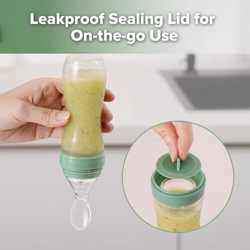 Pea green silicone baby food dispenser spoon held in hand to illustrate one-handed feeding use.