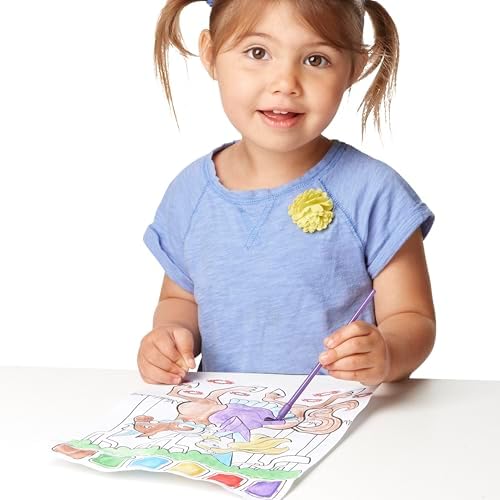 Child using the included wet paintbrush to activate colors on the princess activity book