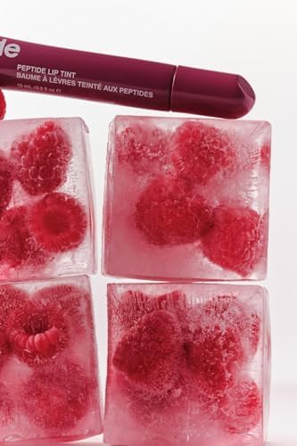 Rhode skin peptide lip tint tube in Raspberry Jelly highlighting the size and premium branding.