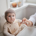 Close-up view of the soft flexible tips on the Mushie first stage infant feeding spoons.