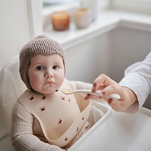 Close-up view of the soft flexible tips on the Mushie first stage infant feeding spoons.