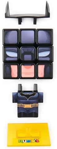 Rubik's Batman fidget toy displayed on an office shelf alongside other comic book collectibles.