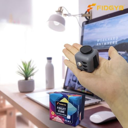 Compact quiet stress buster cube held in hand to demonstrate portability and scale.