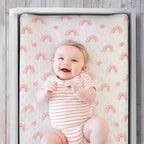 The Peanutshell baby changing table sheet showing floral and rainbow pattern details