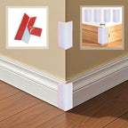 Self adhesive rubber corner guard applied to a white skirting board