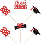 Assorted glitter diploma and graduation cap cupcake toppers for party.