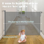 Gray retractable mesh pet gate extended across a wide hallway opening.