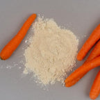 Birch And Meadow Carrot Powder mixed into a green smoothie glass