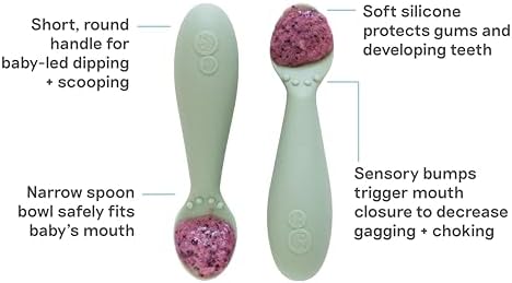 Infant holding the short round non slip silicone handle easily.