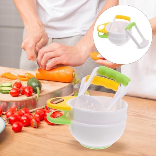 Manual baby food grinder bowl filled with freshly pureed organic carrots
