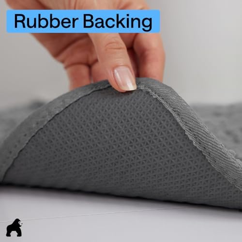 Gorilla Grip SoakStopper mat being loaded into a washing machine for cleaning