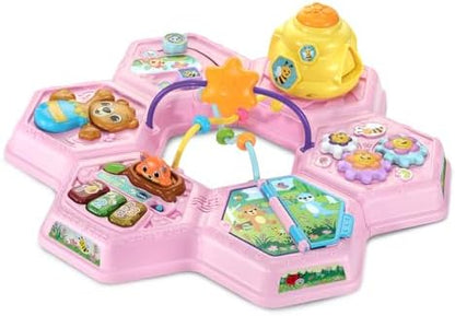 Side perspective of the VTech two-in-one play table configured low to the ground for infant floor play.