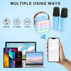 Dual wireless microphones for duet singing next to a mini portable party speaker system.