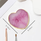Close up of heart shaped nail design display board with gold trim