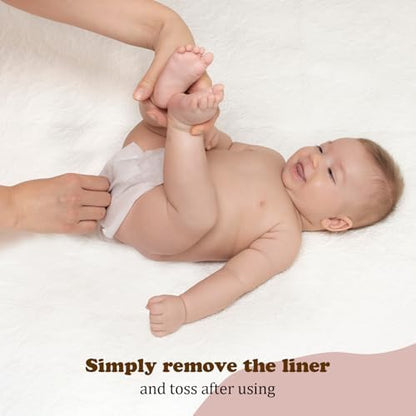 Disposable liner being placed inside a cloth diaper