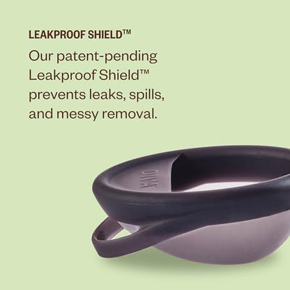Medical grade silicone menstrual disc held in hand to show size and flexibility.