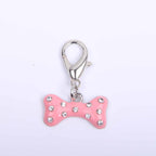 Pink enamel rhinestone bone charm hanging on a pet accessory chain