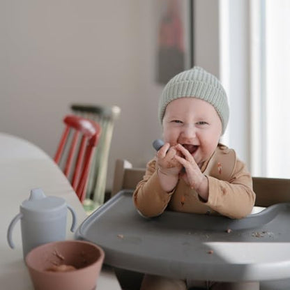 Mushie silicone starter utensils in pastel blush showing the soft flexible tip safe for baby gums