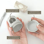 Moodie baby diaper trash bag dispenser attached to silicone strap