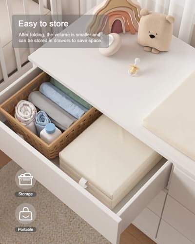 White YACODAVO portable travel changing pad being wiped clean with a cloth after a diaper replacement