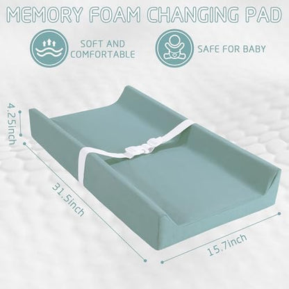 Hombys nursery changing pad styled on a wooden dresser