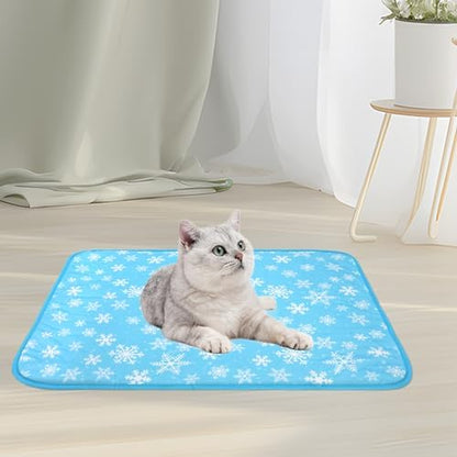 A fluffy domestic cat relaxing comfortably on top of the blue NACOCO snowflake cooling mat.