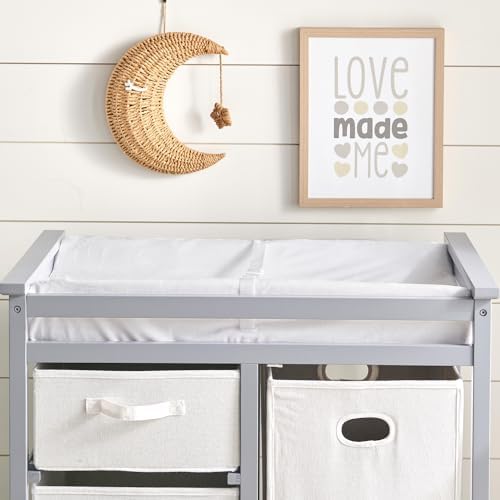 Badger Basket changing table pad staged in nursery setting