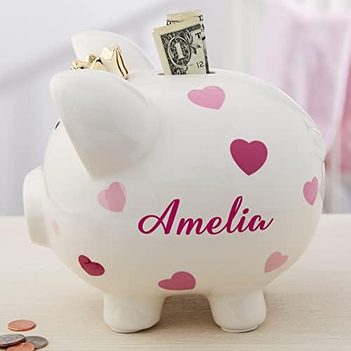 Side angle view of the Personalization Universe girl ceramic money saving box highlighting the pink heart and polka dot patterns