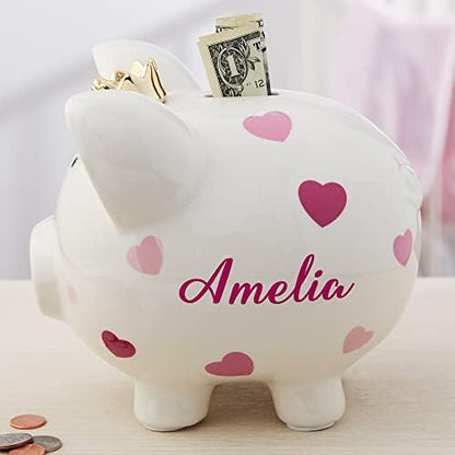 Side angle view of the Personalization Universe girl ceramic money saving box highlighting the pink heart and polka dot patterns