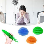 Seven Seas squishy desk toy compressed into a compact shape on a clean white surface.
