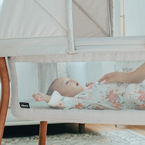 Lightweight newborn bassinet with mesh side panels showing waterproof mattress