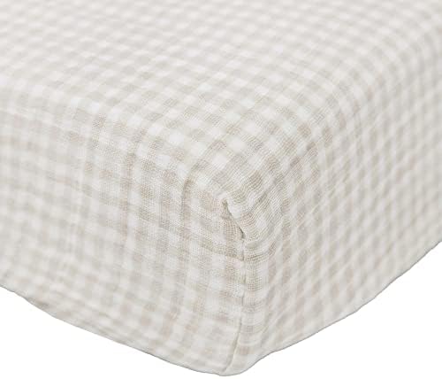 Close up view of the breathable cotton muslin fabric texture and neutral plaid design.