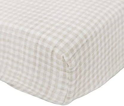 Close up view of the breathable cotton muslin fabric texture and neutral plaid design.