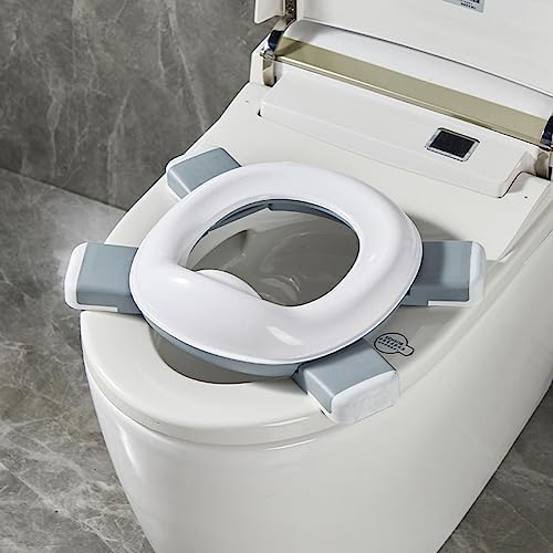 Toddler using Spark Moments foldable potty training toilet outdoors