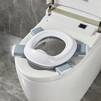 Toddler using Spark Moments foldable potty training toilet outdoors