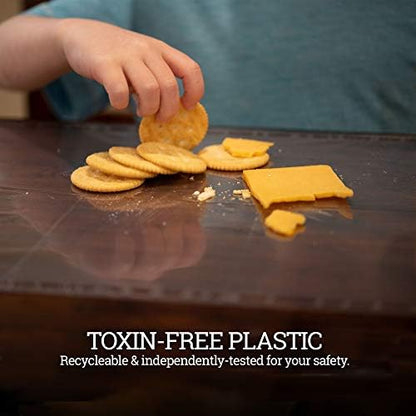 Child utilizing the transparent stick on protector for messy painting and dough crafting at school