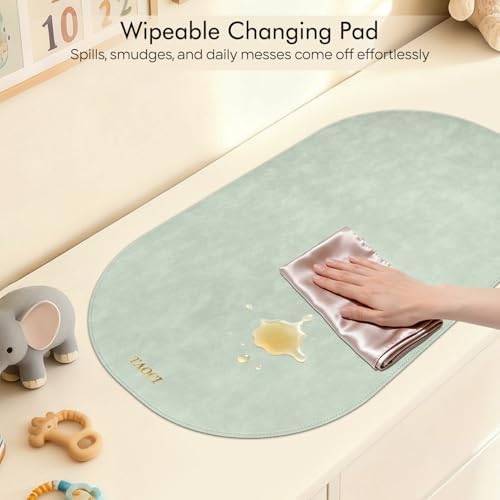 TAOCI lightweight diaper changing pad being slipped into a stylish baby tote bag.