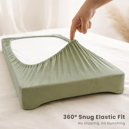 Konssy green leaf and solid color baby changing pad covers neatly folded