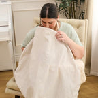 Mother using My Brest Friend breathable nursing cover in public