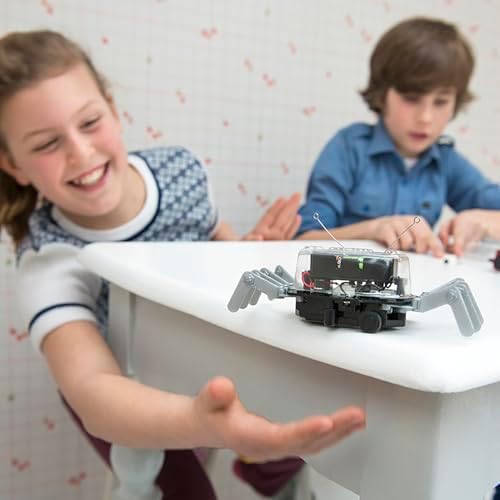 Kids playing with 4M 5576 Table Top Robot engineering toy