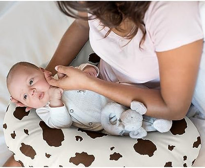 Close up of ivory and brown cow print pattern on nursing pillow slipcover