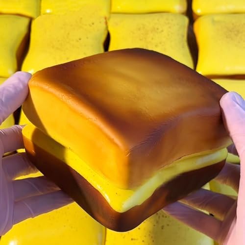 Adult hand squeezing a soft yellow polyurethane fidget toy for stress relief
